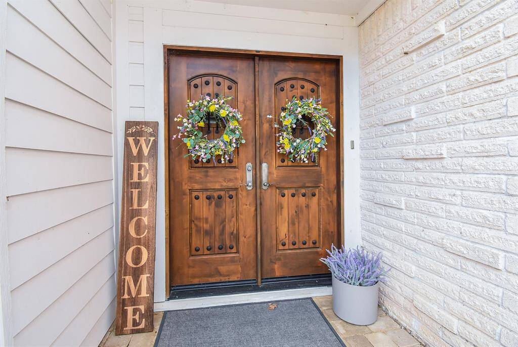 Gorgeous custom knotty alder front doors with speakeasy greet you as you enter this fabulous home. As the sign says, WELCOME!