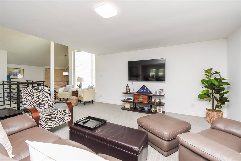 Large Den area shows the custom horizontal railing.  Wall insulation and weatherproofing was completed with the remodel