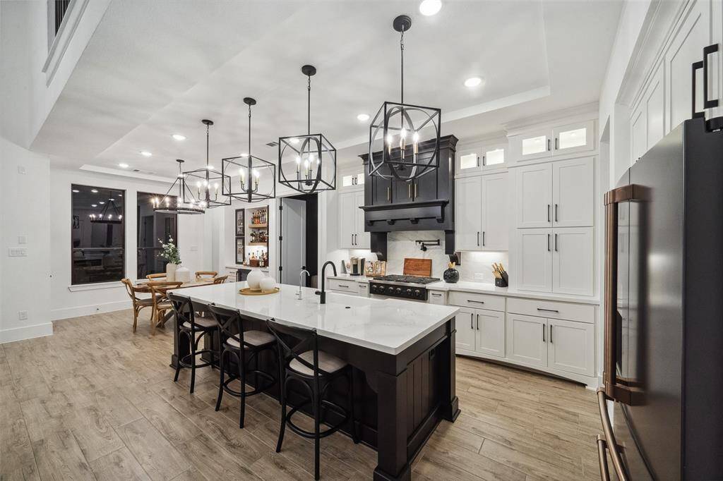 Under mount lighting  and upper cabinets elevate the kitchen space