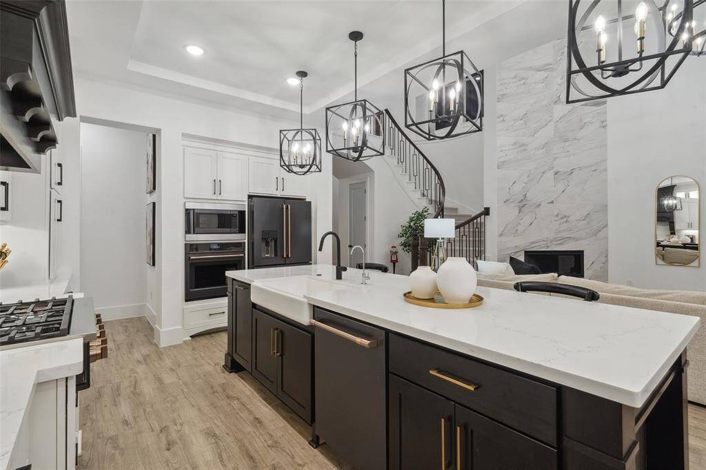 Kitchen features extended island, high end appliances, pot filler, farmhouse sink and water filtration system