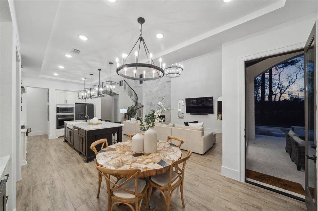 Elegantly appointed breakfast nook opens to expansive covered patio and outdoor kitchen