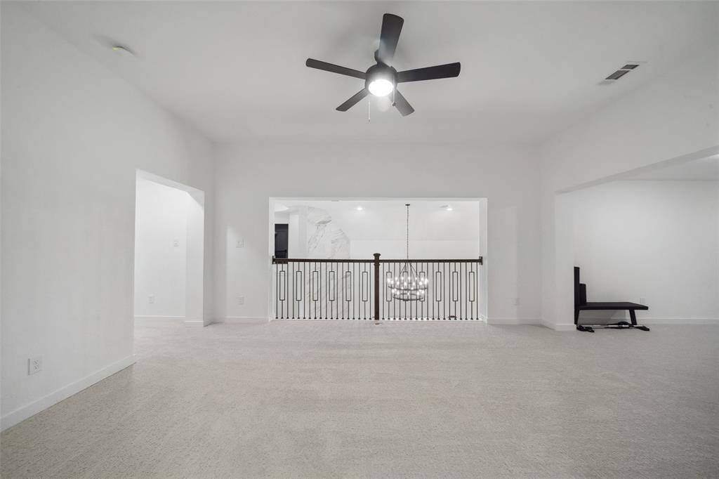 Spacious flex space overlooks the living room