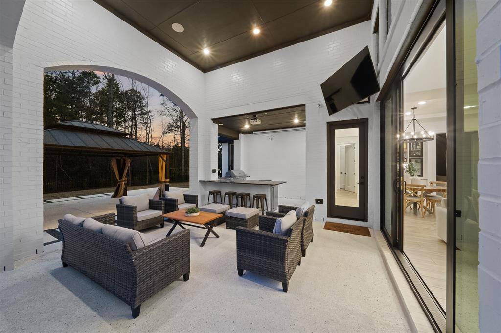 Covered patio with vaulted ceiling and picturesque golf course views. Pull down projection screen and projector are included