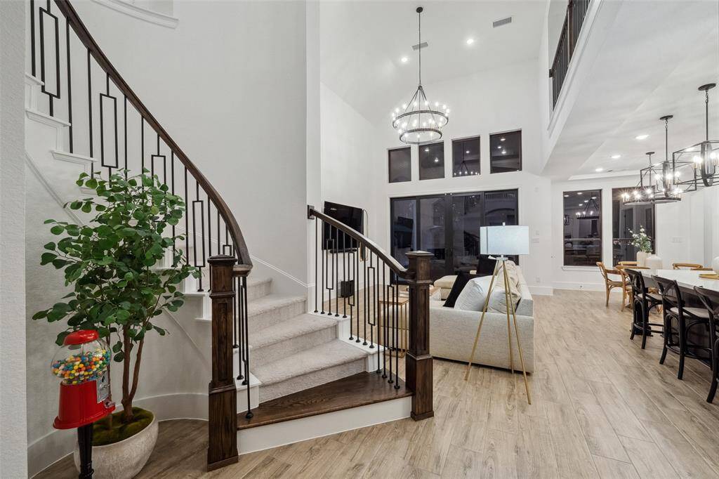 A curved staircase enhances the home's timeless beauty, making a bold statement upon entry