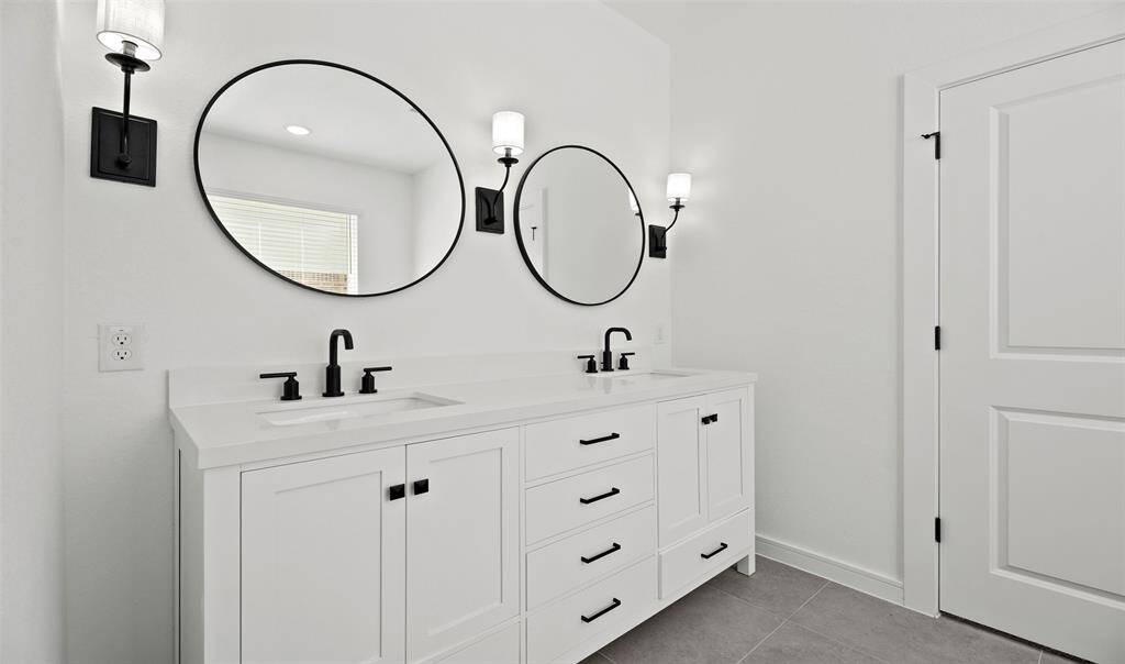 Relaxing primary bath with dual sinks (*Photo not of actual home and used for illustration purposes only.)
