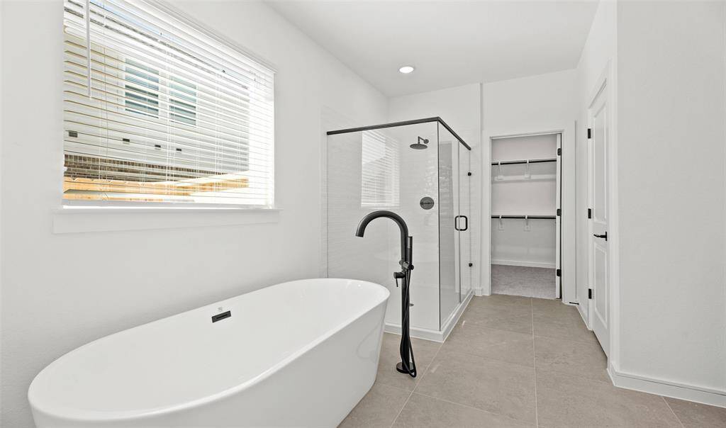 Serene primary bath with freestanding tub and shower (*Photo not of actual home and used for illustration purposes only.)