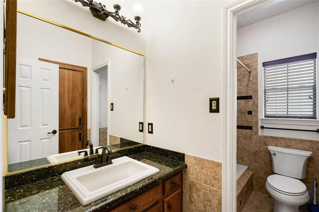 2nd Bathroom with vanity, shower/tub combination.