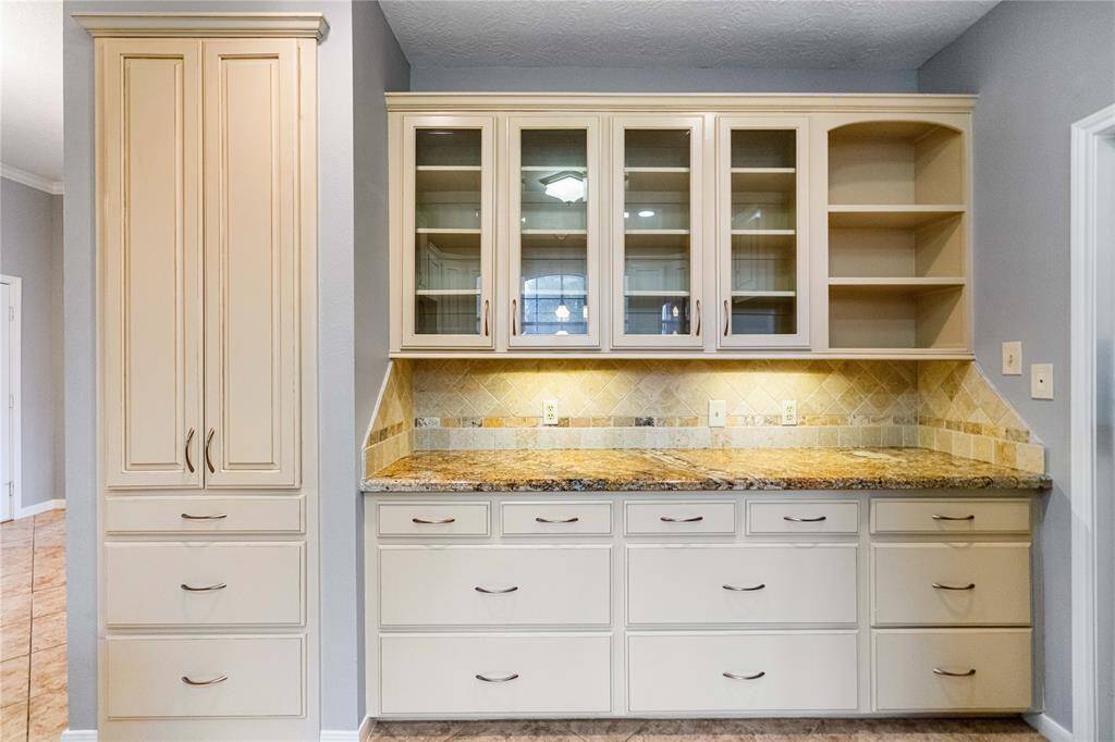 Coffee bar/bar area with additional storage space and overhead cabinets.  Updated texture and paint.