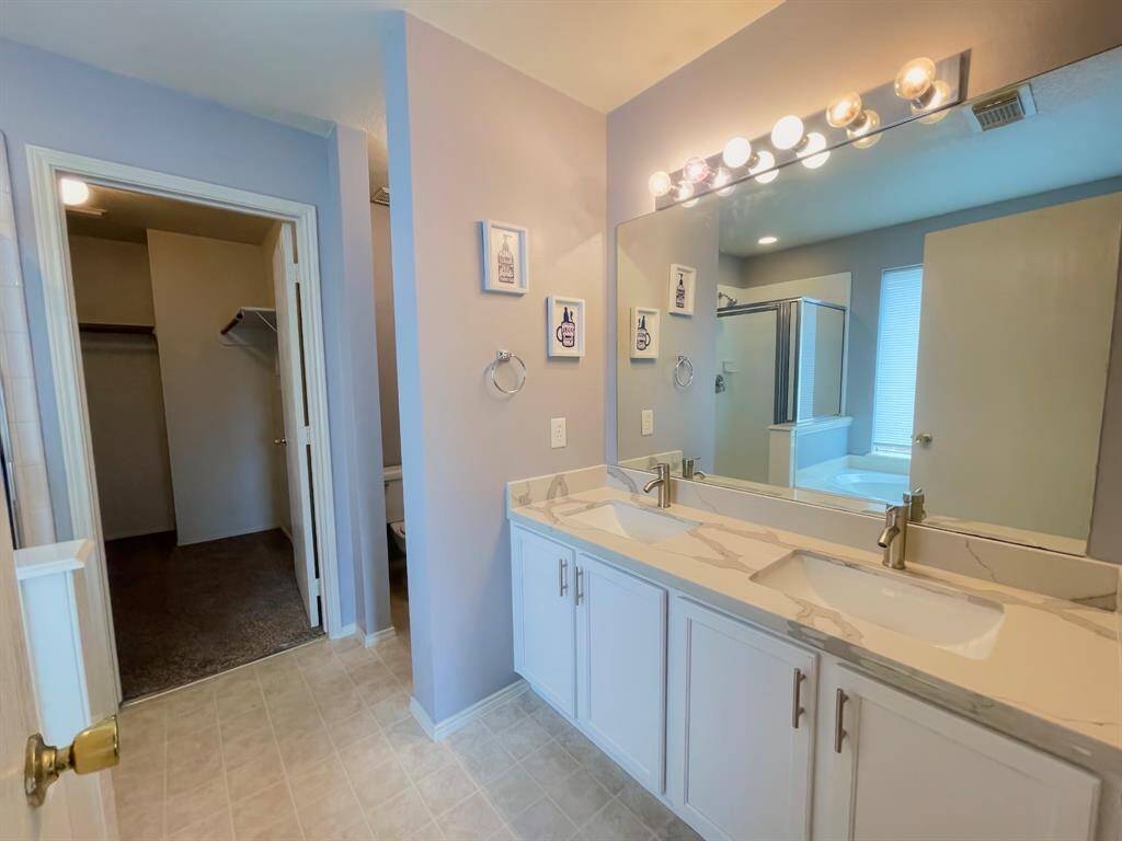 Primary bath with remodeled quartz counters and faucets