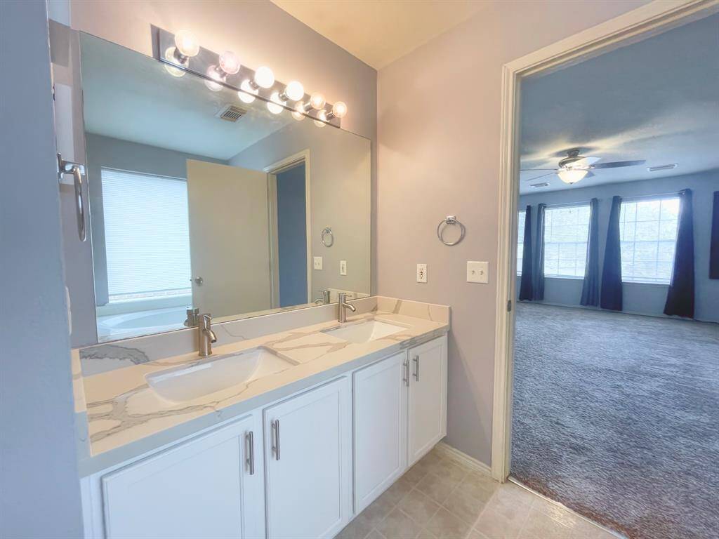 Primary bath with remodeled quartz counters and faucets