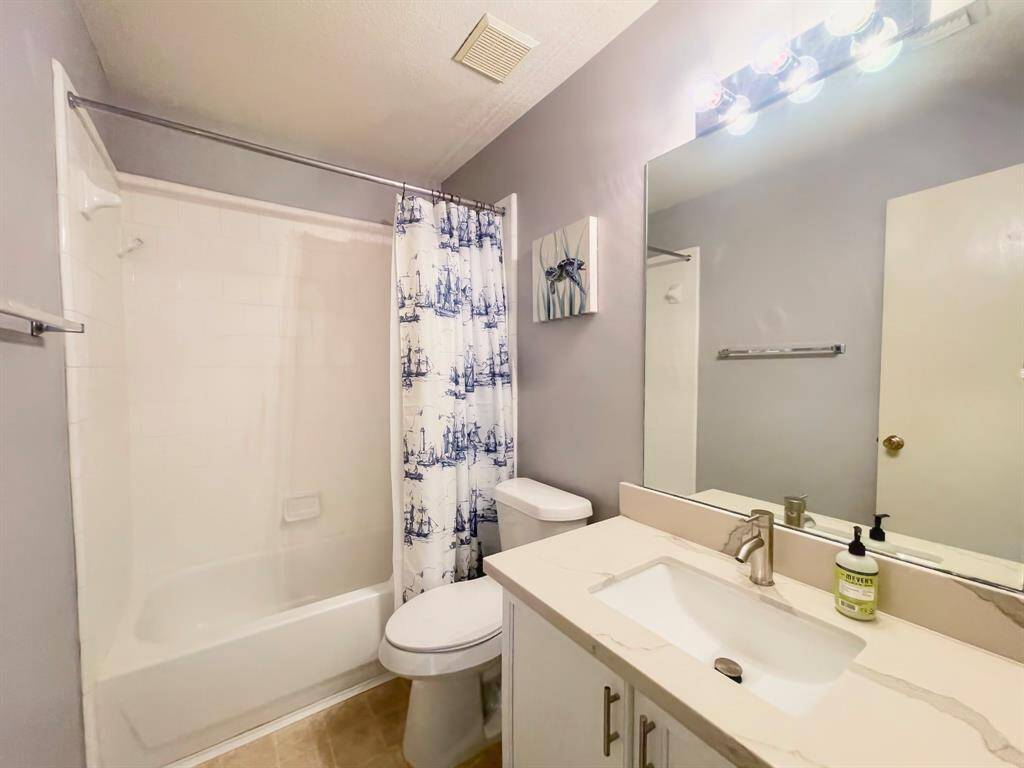Secondary bath with remodeled quartz counters and faucets