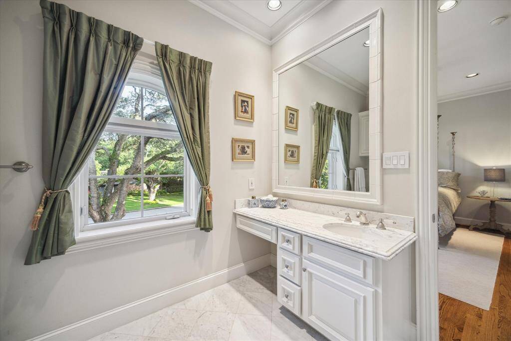The adjoining ensuite bathroom includes a make-up vanity.