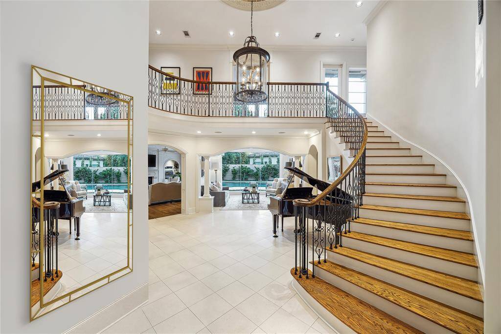 The stately foyer, with its sweeping stair case, is open to the second floor. What a wow-factor!