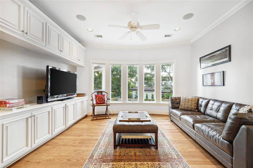 This multi-purpose room in the center hall has lots of storage and motorized shades. Scrabble, Anyone?