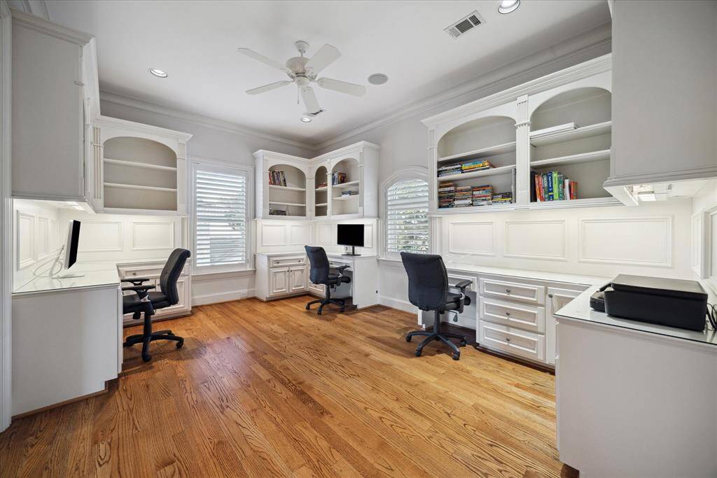 A designated second-floor office with three built-in work stations could be turned into the ultimate craft room!