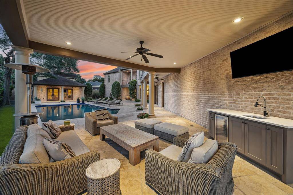 Walk under the covered pathway from any of your back doors to the loggia and summer kitchen with gas grill, quartz countertop, and stylish cabinetry.