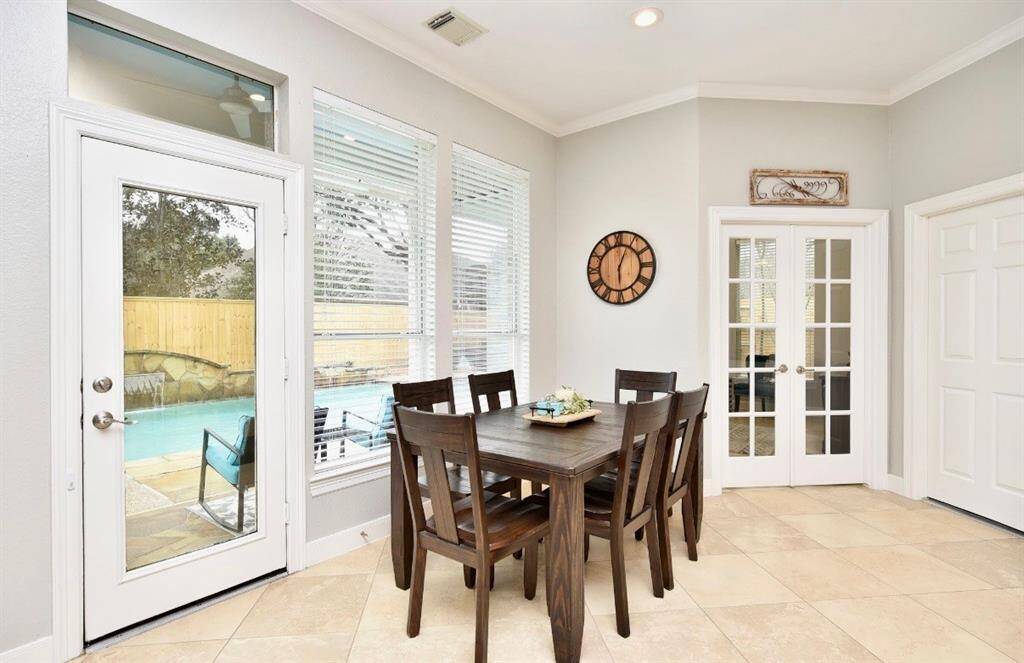 The breakfast nook is bright and with terrific views of the sparkling pool.