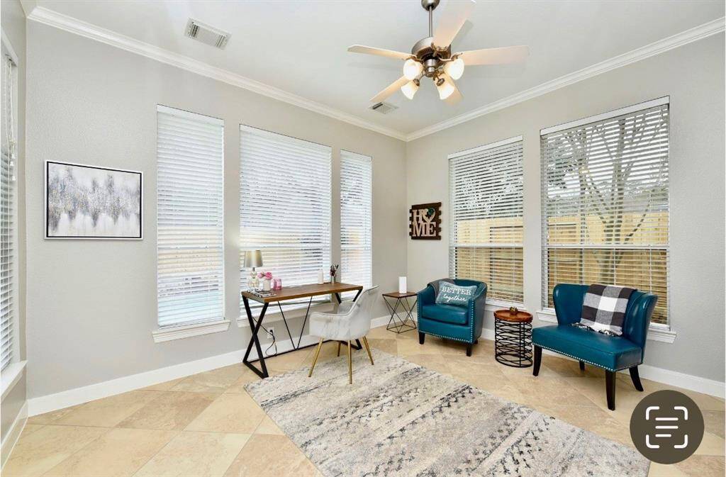 The flex room is perfect for a second office, library, or home gym with bright views of the backyard's pool and outdoor kitchen.