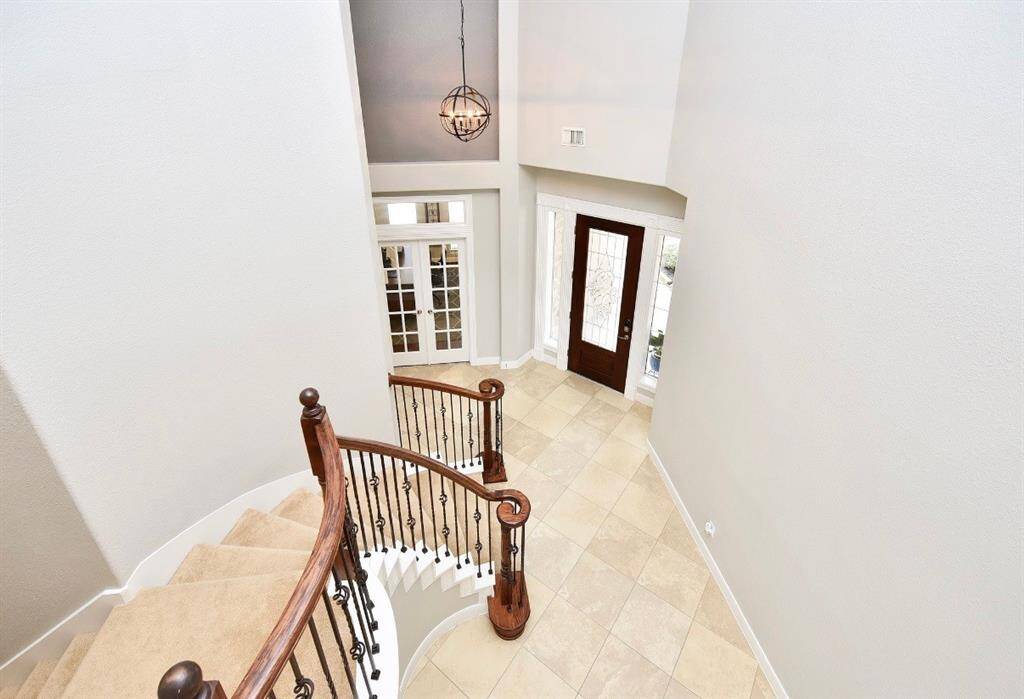The view from the second floor gives perspective to the impactful entry which greets guests upon arrival to this feature-rich home.