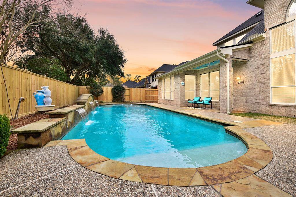 The serene backyard, waterfall and resort quality pool feature exceptional privacy for those seeking a private retreat. Includes an outdoor kitchen for entertaining.