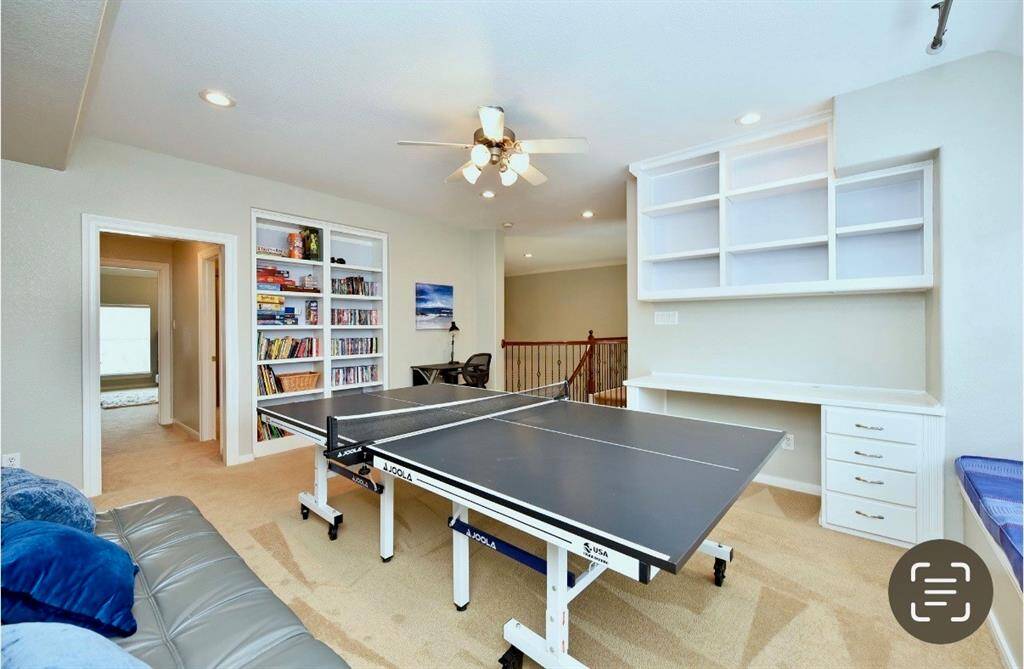The second floor gameroom is spacious enough to gather friends and family around table tennis or pool tables while entertaining.