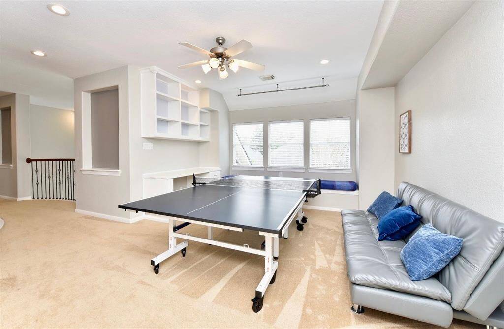 The second floor gameroom is spacious enough to gather friends and family around table tennis or pool tables while entertaining.