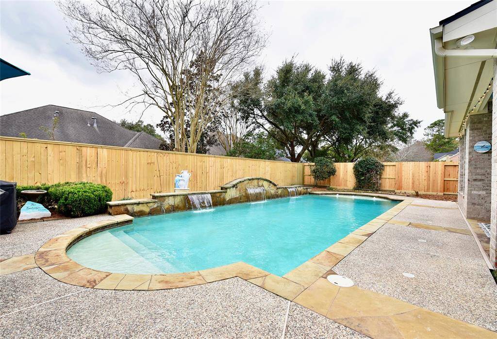 This backyard retreat is feature rich with a covered patio, covering outdor kitchen and inviting pool with sunshelves perfect for hosting guests and creating poolside magic moments with the family.