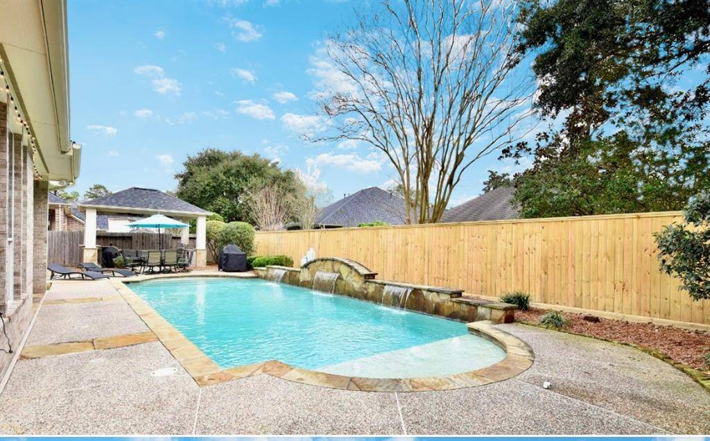 The serene backyard, waterfall and resort quality pool feature exceptional privacy for those seeking a private retreat.