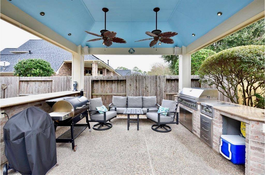 A fully equipped outdoor kitchen awaits backyard entertaining and warm weather gatherings.