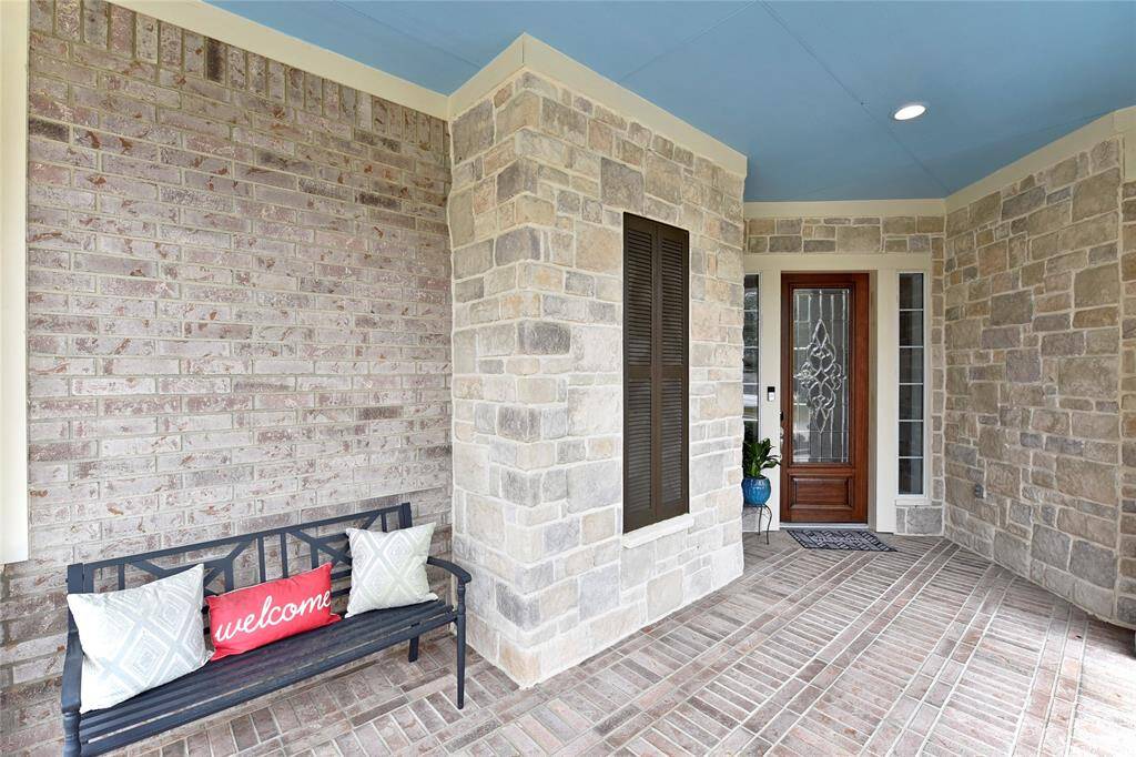 The front porch is large with a seating area for people watching and visiting with friends in the neighborhood.
