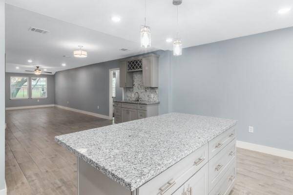Beautiful kitchen cabinets with soft close cabinet doors and drawers. Granite countertops, crown molding, large kitchen sink and new appliances that features a gas stove.