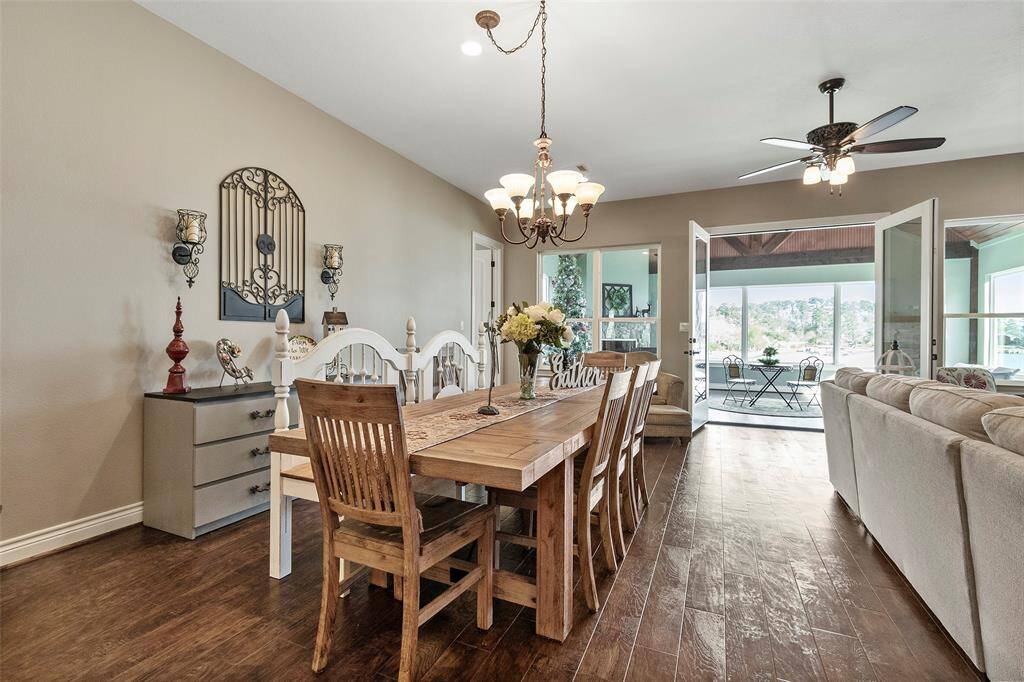 Perfect place for your dining table. Beautiful light fixture brings so much charm to this area.