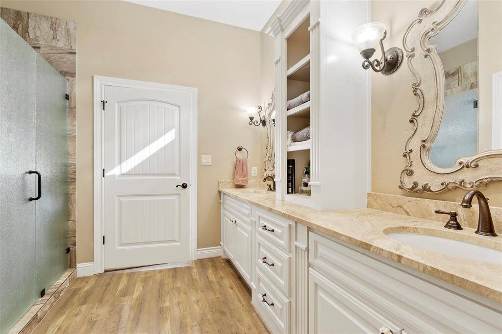 the primary bath has a spacious walk in shower. This bathroom creates a luxurious and functional space.