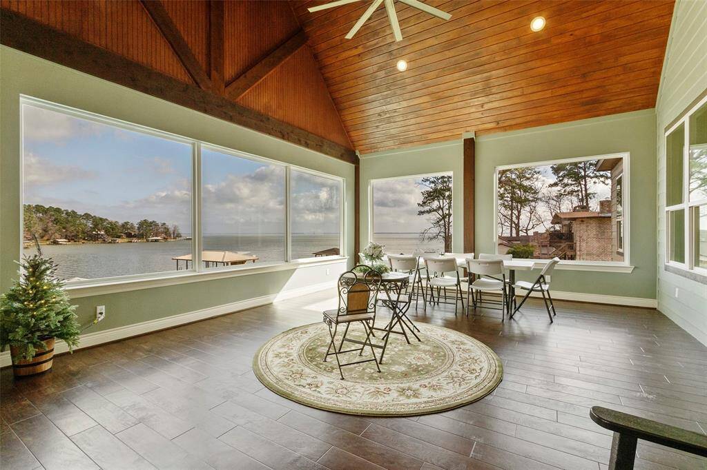Another view of this outstanding sunroom. Large windows help to bring the natural light in. Perfect for relaxation or entertaining, it offers a serene and inviting atmosphere.