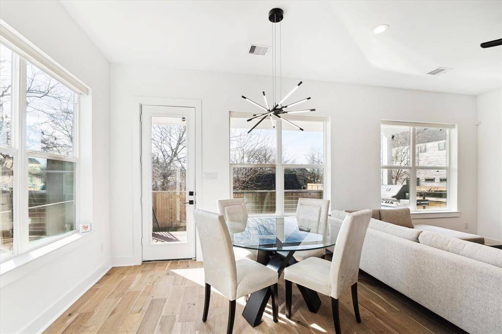 A stunning chandelier accents the dining area, which also overlooks the rear porch and back yard.