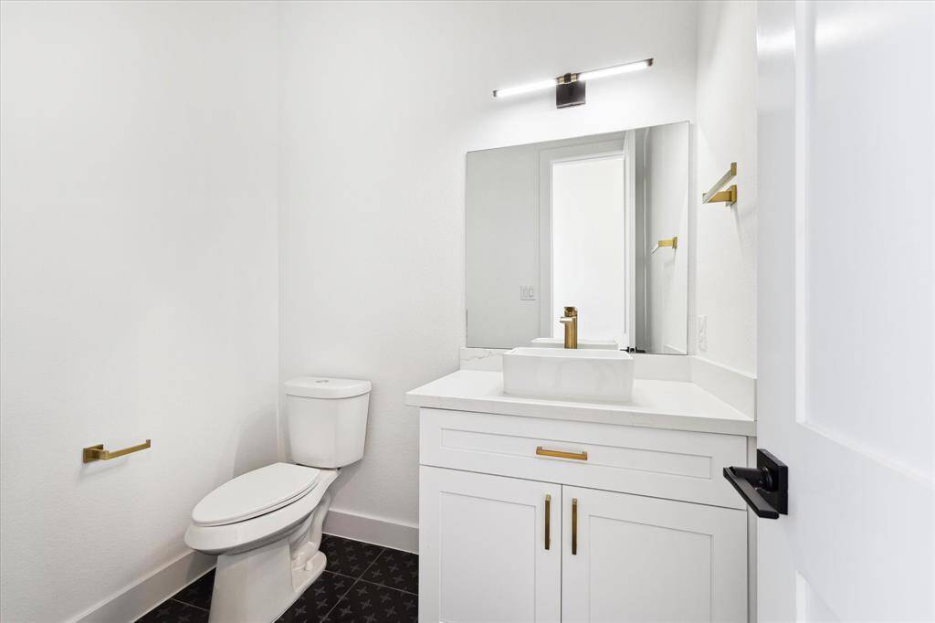 The half bath is tucked away down the hall from the living areas.