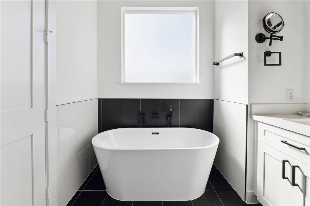 View of soaking tub and frosted window which provides the perfect balance of privacy and natural light.