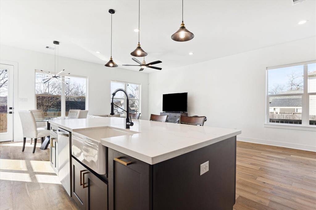 Kitchen island with deep farm sink, storage, room for several stools for friends to pull up.