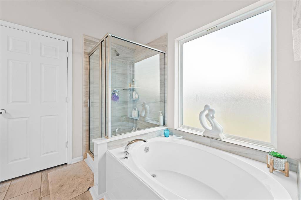 Master bathroom with separate bathtub and shower