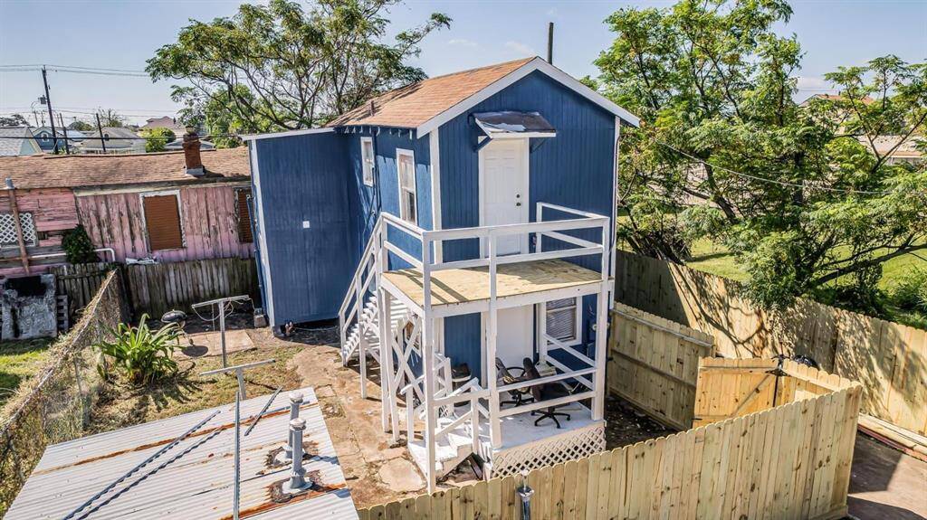 Arial view of charming duplexes with private outdoor space, nestled in a serene neighborhood setting.