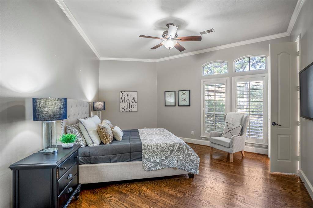 One of the highly desirable features of this home, is there are 2 bedrooms down, this is the second bedroom down with beautiful hand scraped wood floors, neutral tones and plantation shutters.