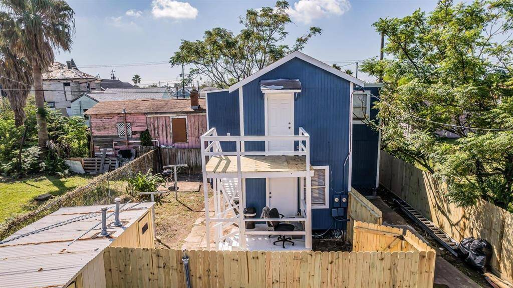 Aerial view showcasing spacious back duplexes with private fenced yards, nestled in a lush, green setting.