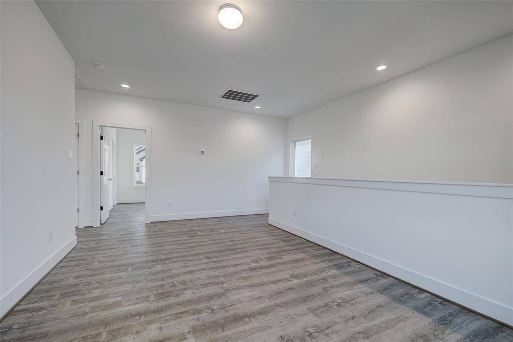 Alternate view of the game room. Large windows overlook the front of the community and flood the space with natural light.
