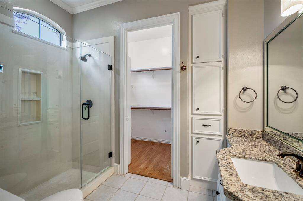 This is the bathroom that feeds off the second bedroom down, with glass enclosed shower, granite countertops and plenty of closet space.