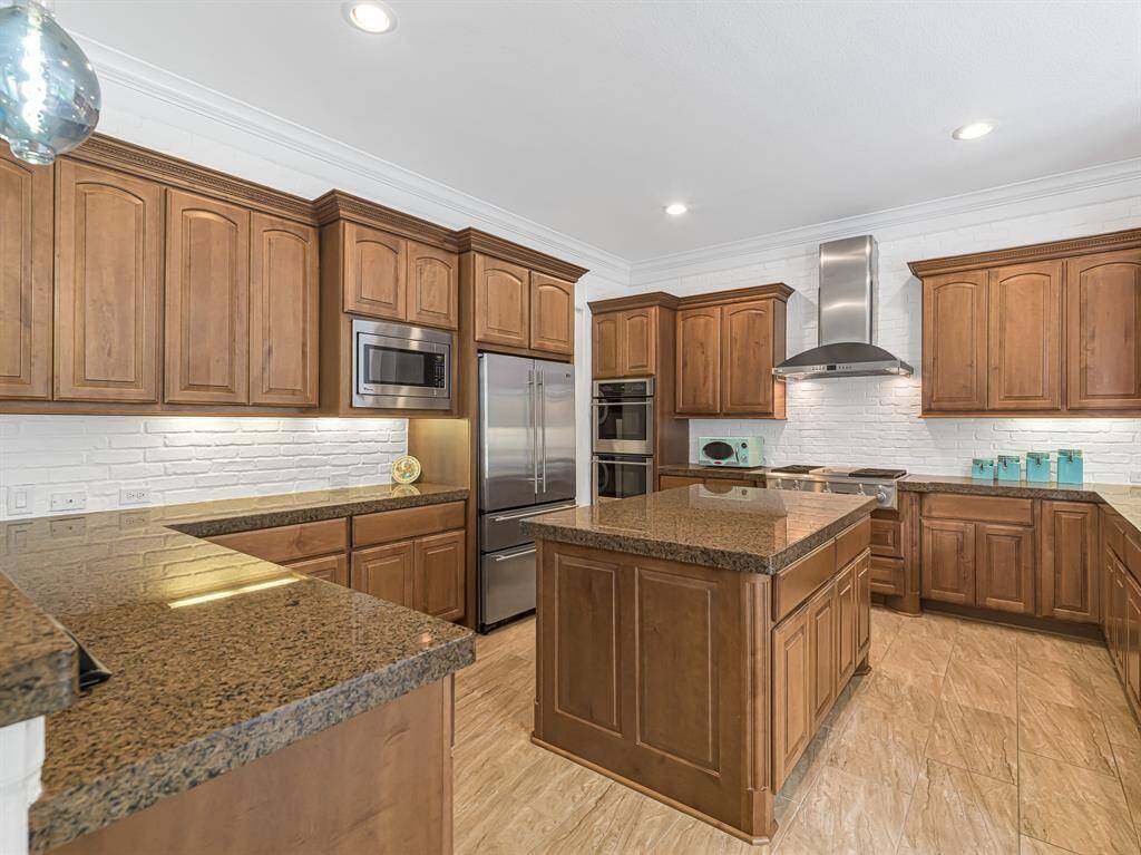 Kitchen is complete with double ovens, large gas cooktop, ample cabinetry and a large center island