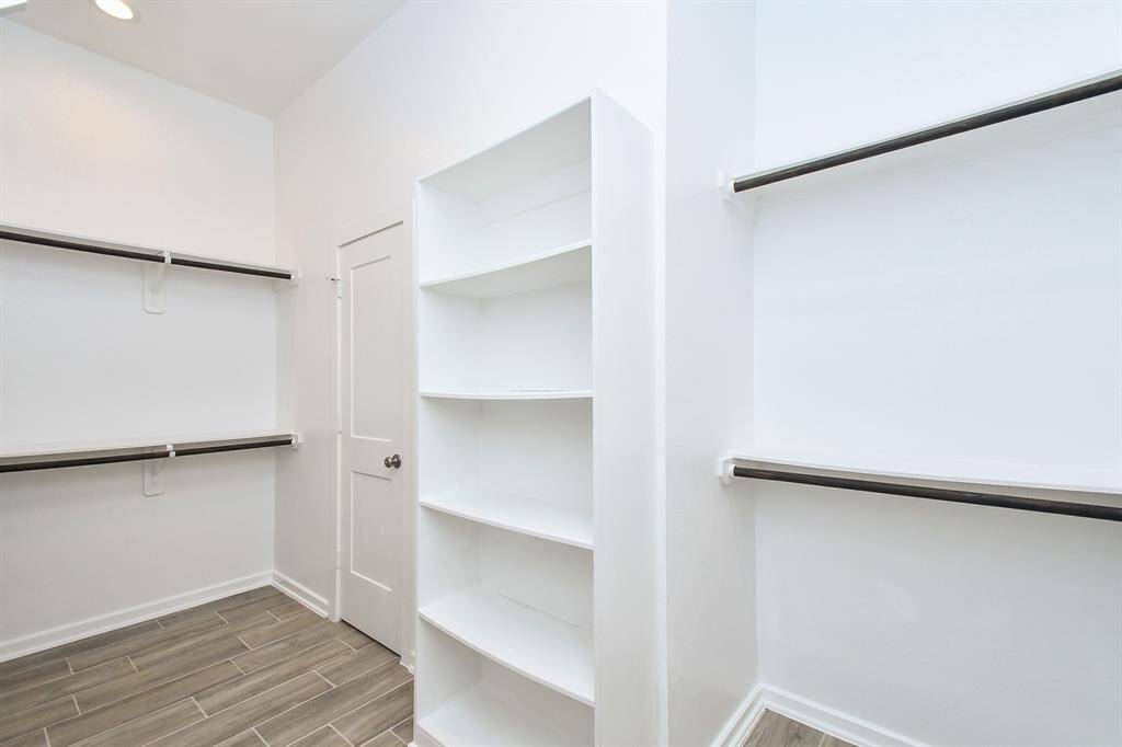 The spacious master bedroom closet is a luxurious walk-in design, offering ample storage and organization. Featuring custom shelving, and hanging racks, it provides plenty of room for clothing, shoes, and accessories. With bright lighting and a thoughtfully designed layout, this closet combines functionality with elegance, creating the perfect personal dressing space.