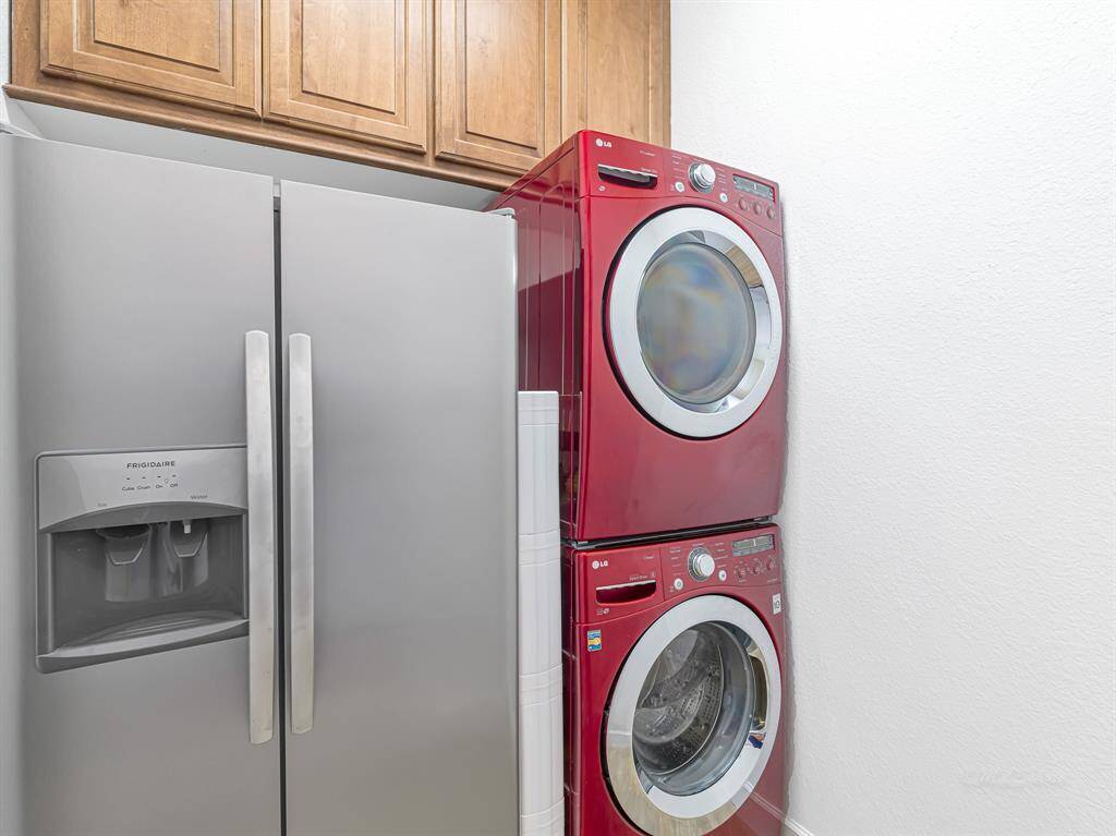 Laundry room with cabinet and plenty of space for an extra fridge (which will stay with the house)