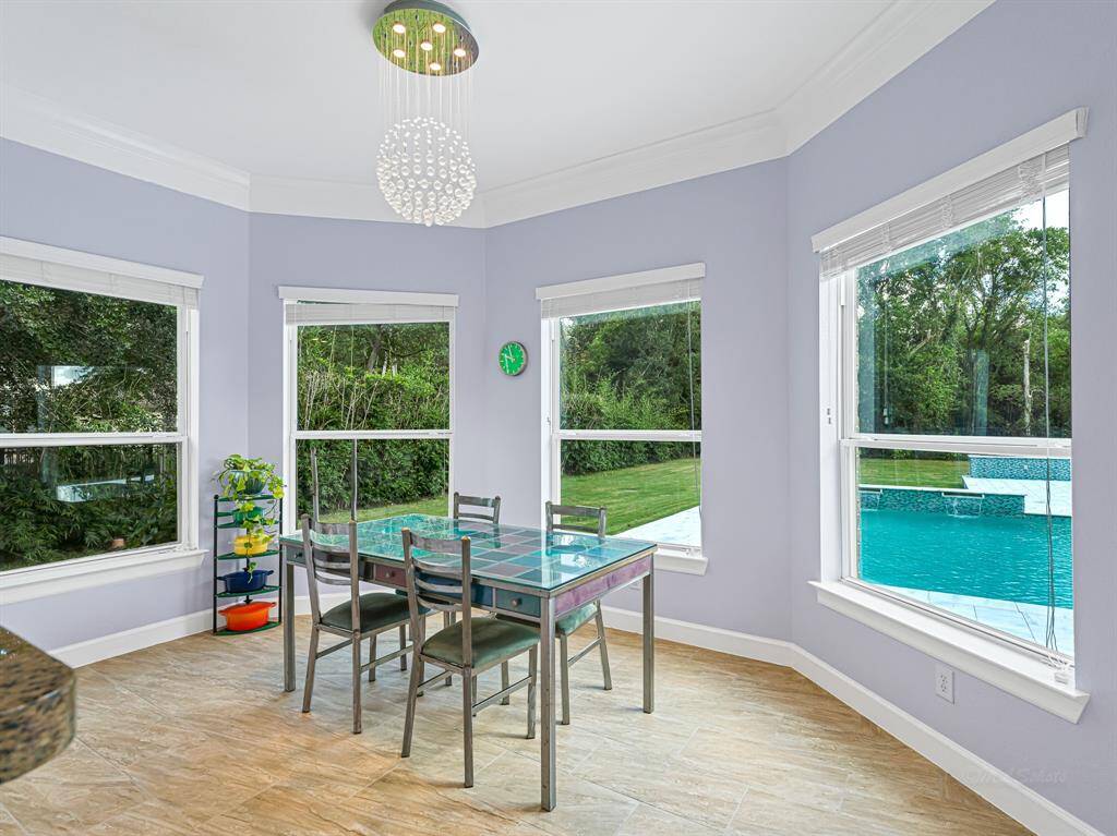 Imagine having morning coffee in the breakfast room with this beautiful view of the pool and backyard