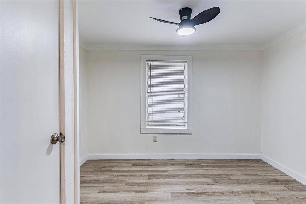 Spacious primary bedroom featuring sleek wood flooring and abundant natural light.