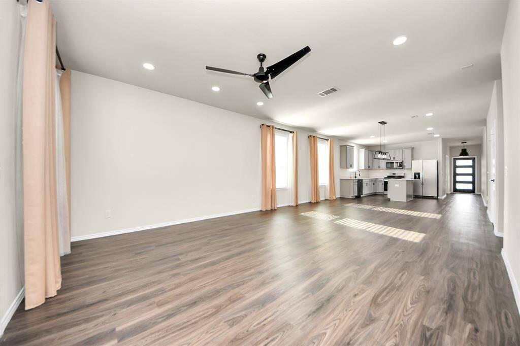 Expansive Living Area; Perfect for family gatherings. Recessed light additions. Stylish ceiling fans ensure comfort in key spaces.